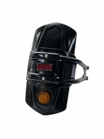 Black leather glove with a brown button on a white background