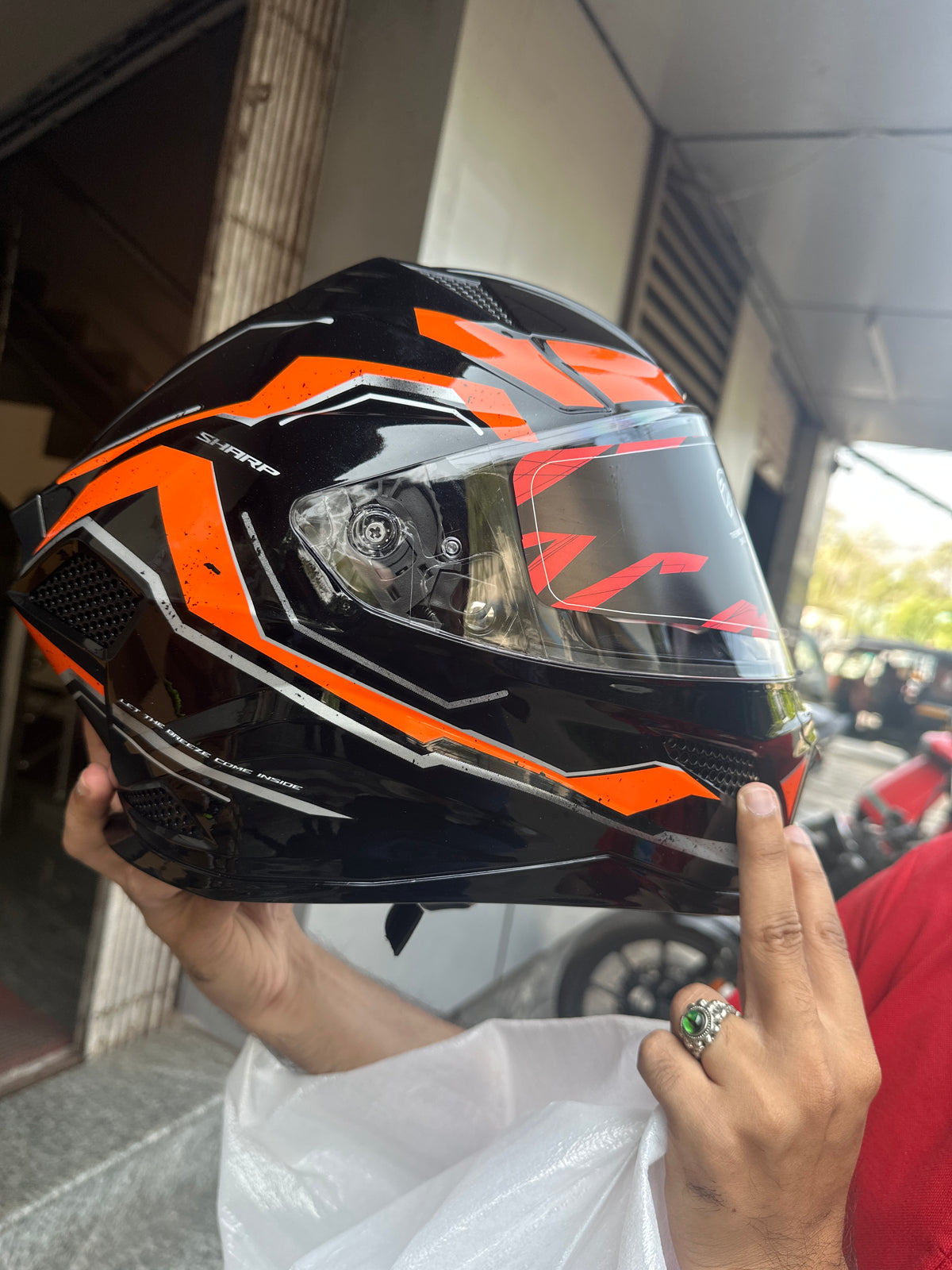Steelbird SBH 25 Sharp Spirit Glossy Black/Orange Helmet combines safety with a sleek design, offering comfort and durability for riders.