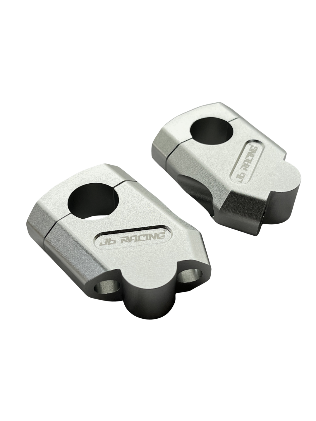 A pair of metallic silver JB Racing motorcycle handlebar clamps on a clean white background.