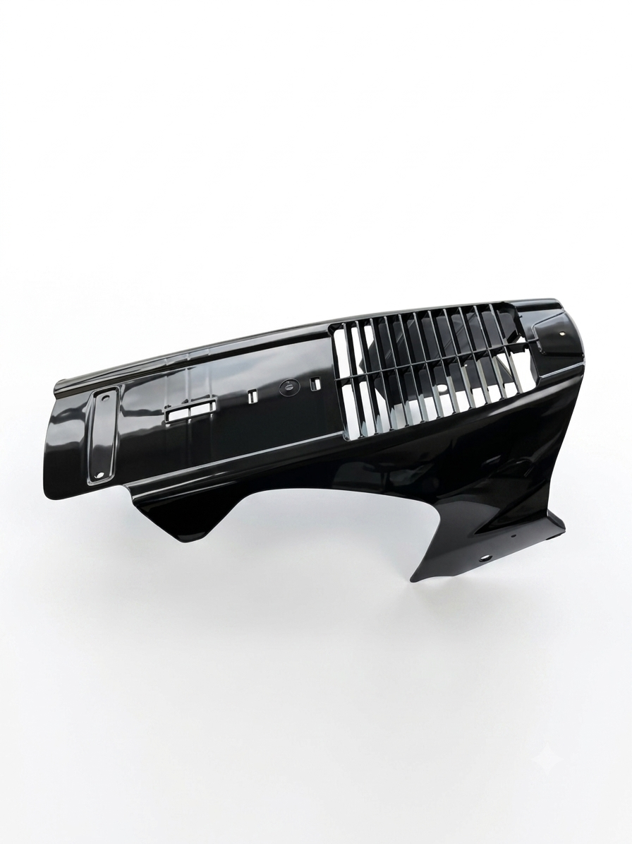A glossy black plastic automotive bumper lip or front fascia trim piece with horizontal grille slats, photographed on a clean white studio background.