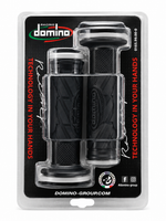 A pair of black motorcycle handlebar grips in their original blister packaging, branded with the 'Racing Domino' logo on a black backing card.