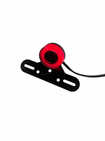 Red light bulb on a black bracket with a white background