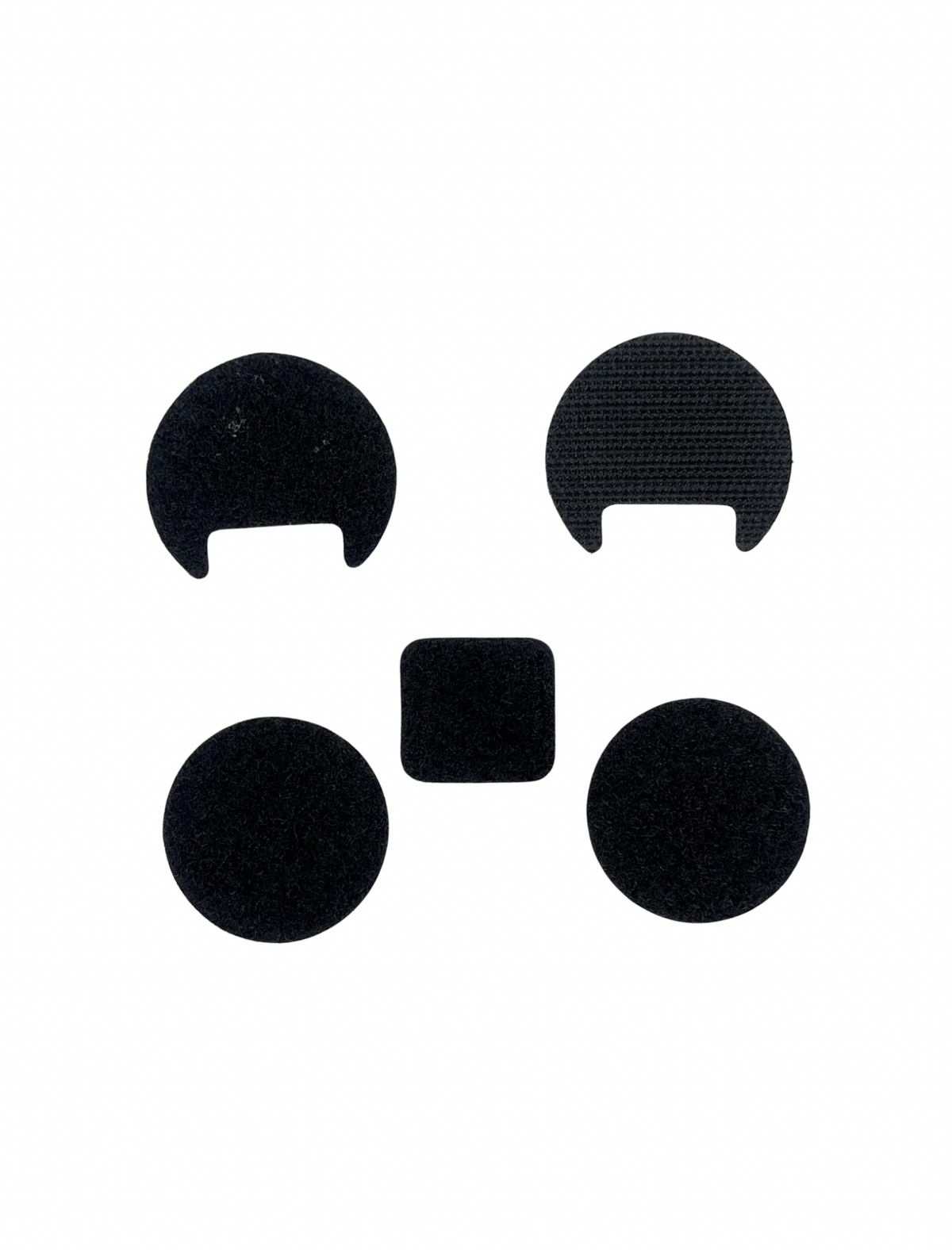 Black circular and square adhesive patches on a white background