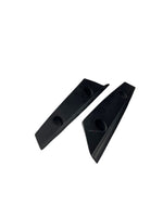 Two black triangular rubber blocks on a white background