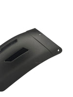 Black plastic cover with cutouts on a white background