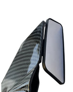 Carbon fiber-textured car mirror on a white background