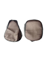 Pair of brown leather saddle pads on a white background